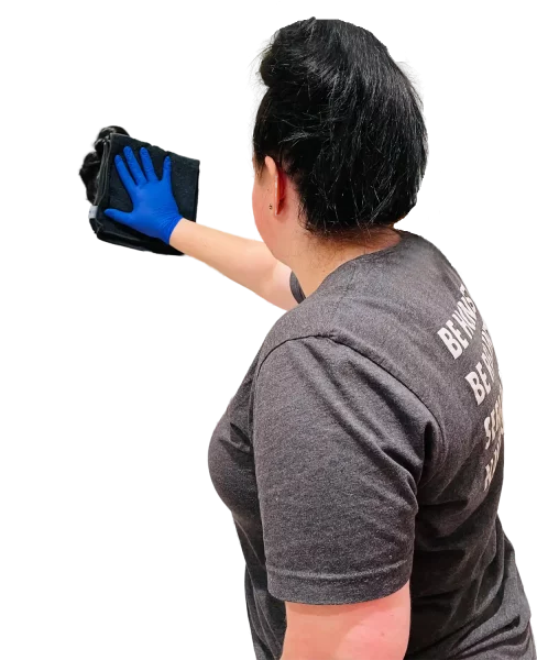 Premier Janitorial employee wiping mirror